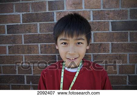 Vietnamese Boy Against Brick Wall Of An Esl School; Guelph Ontario Canada View Large Photo Image Stock Photo - Vietnamese Boy Against Brick Wall Of An Esl School; Guelph Ontario Canada. Fotosearch