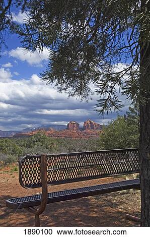 Stock Image - View Across Red Rock State Park With A Metal Bench In The Foreground.. Fotosearch