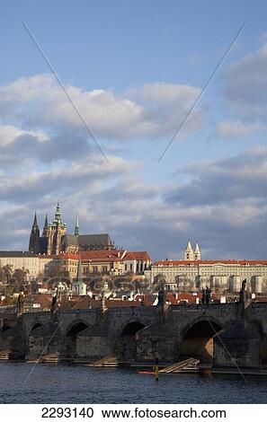 Stock Image - View across the River Vltava towards the Charles Bridge and the Castle District, Prague, Czech Republic, Europe. Fotosearch