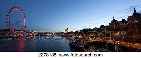 Stock Photography - View across the Thames towards The London Eye and Houses of Parliament, Westminster; London, England. Fotosearch