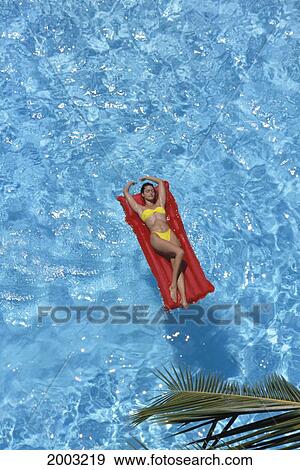 View From Above Woman In Pool Laying On Red Air Mattress, With Yellow Swimsuit View Large Photo Image Stock Photo - View From Above Woman In Pool Laying On Red Air Mattress, With Yellow Swimsuit. Fotosearch