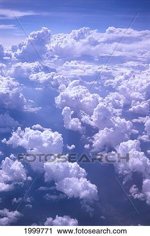 Stock Image - View From Airplane Of Blue Sky And Small Cottonball Clouds C1729. Fotosearch