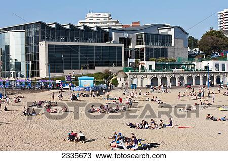 Stock Image - View From Bournemouth Pier Of Sunbathers At Bournemouth Beach; Bournemouth, Dorset, England, Uk. Fotosearch
