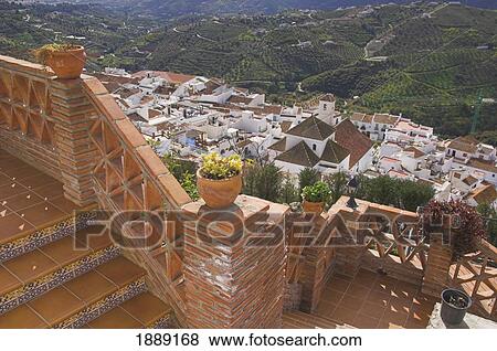 Stock Photo - View From Brick Patio Of Small Whitewashed Village Nestled In Mountains. Fotosearch