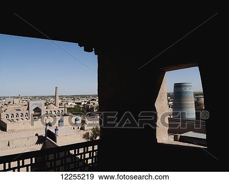 Stock Photo - View from city walls of Mohammed Rakhim Khan Madrassah (left) and Kalta Minar (right), Ichan Kala Old City, Kizilkum desert; Khiva, Khwarezm region, Uzbekistan. Fotosearch