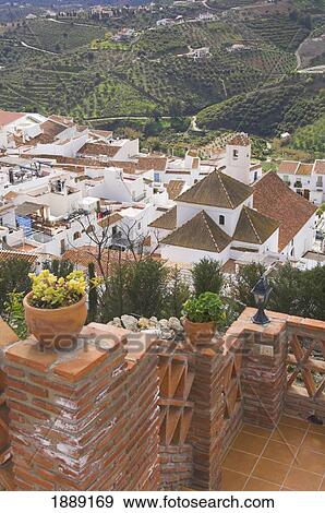 Stock Photo - View From Patio Of Whitewashed Village Nestled In Mountains. Fotosearch