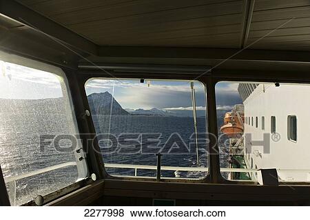 View from the bridge of the Hurtigrunta cruise ship MS Nordlys in wintertime after crossing the Arctic Circle; Norway View Large Photo Image Stock Photo - View from the bridge of the Hurtigrunta cruise ship MS Nordlys in wintertime after crossing the Arctic Circle; Norway. Fotosearch