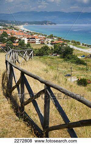 Stock Photo - View from the hill top site of the akanthos ruins with a view of mediterranean sea and the village below; ierissos halkidiki greece. Fotosearch