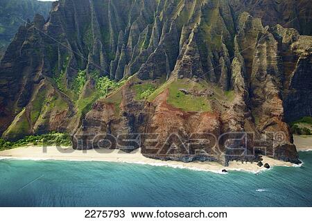 Stock Image - View of a beach along the coast of an hawaiian island; Na Pali coast of Kauai, Hawaii, United States of America. Fotosearch
