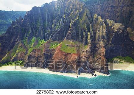 Stock Image - View of a beach along the coast of an hawaiian island; Na Pali coast of Kauai, Hawaii, United States of America. Fotosearch