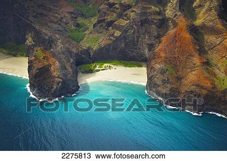 View of a beach along the coast of an hawaiian island; Na Pali coast of Kauai, Hawaii, United States of America View Large Photo Image Stock Image - View of a beach along the coast of an hawaiian island; Na Pali coast of Kauai, Hawaii, United States of America. Fotosearch