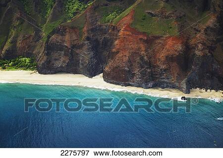 View of a beach along the coast of an hawaiian island; Na Pali coast of Kauai, Hawaii, United States of America View Large Photo Image Stock Photo - View of a beach along the coast of an hawaiian island; Na Pali coast of Kauai, Hawaii, United States of America. Fotosearch