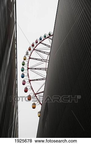 View Of A Ferris Wheel Beside A Tall Building; Tokyo, Japan View Large Photo Image Stock Photo - View Of A Ferris Wheel Beside A Tall Building; Tokyo, Japan. Fotosearch