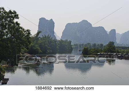 Stock Image - View Of A River With Camel Hill In The Background; Yangshuo, Guangxi, China. Fotosearch