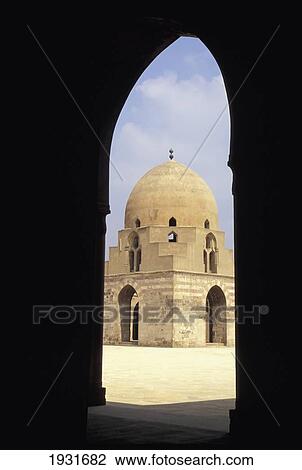 Stock Image - View Of Ablutions Block And Courtyard Of Ibn Tulun Mosque Through An Arch, Cairo, Egypt; Cairo, Egypt. Fotosearch