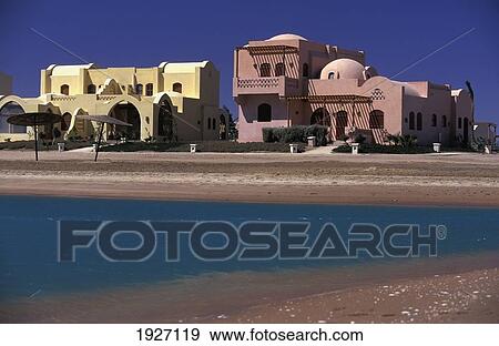 Stock Photo - View Of Beach And Two Buildings. Fotosearch