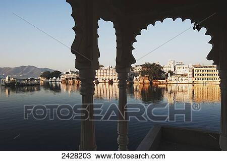 View of buildings along the shoreline of a river framed by an archway; Udaipur, India View Large Photo Image Stock Image - View of buildings along the shoreline of a river framed by an archway; Udaipur, India. Fotosearch