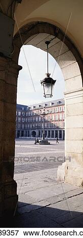 Stock Photo - View Of Buildings Through Archway In Plaza Major. Fotosearch