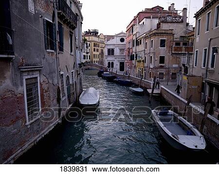 Stock Image - View Of Canal With Boats; Venice, Italy. Fotosearch