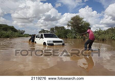 Stock Photograph - View of car crossing river; Kenya. Fotosearch