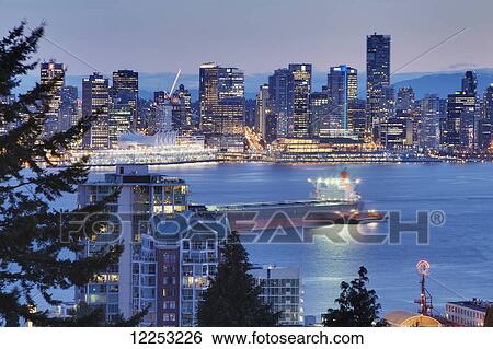 Stock Photograph - View of downtown Vancouver from Lower Lonsdale at dusk; North Vancouver, British Columbia, Canada. Fotosearch