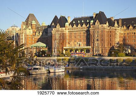 Stock Image - View Of Empress Hotel From Victoria Inner Harbour; Victoria, British Columbia, Canada. Fotosearch
