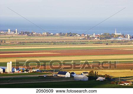 Stock Photo - View Of Fields, Farmland And St. Lawrence River At Sunrise, Kamouraska Village, Bas-Saint-Laurent Region, Quebec. Fotosearch
