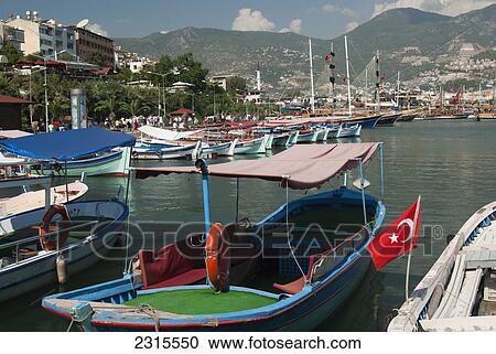 View of fishing boats moored, waiting for taking tourist on cruise around harbor; Alanya, Antalya Province, Turkey View Large Photo Image Stock Image - View of fishing boats moored, waiting for taking tourist on cruise around harbor; Alanya, Antalya Province, Turkey. Fotosearch