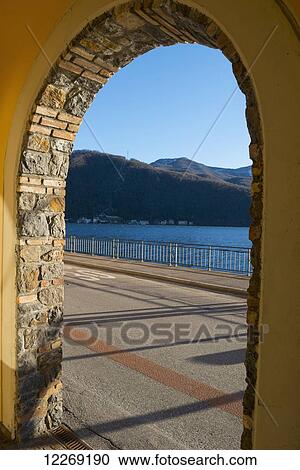 Stock Image - View of Lake Lugano through an archway; Lugano, TIcino, Switzerland. Fotosearch