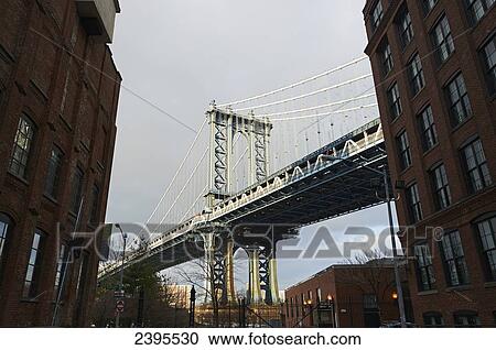 Stock Image - View of Manhattan Bridge from DUMBO Brooklyn; New York City, New York, United States of America. Fotosearch