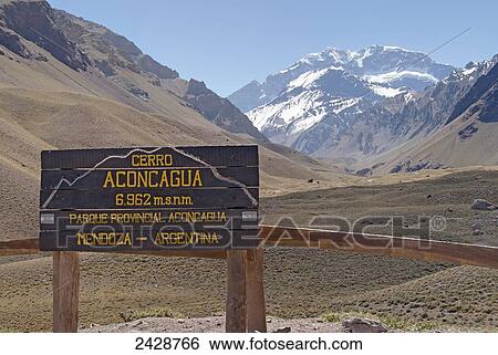 View of Mount Aconcagua from park entrance, with wooden sign indicating altitude; Mendoza, Argentina View Large Photo Image Stock Photograph - View of Mount Aconcagua from park entrance, with wooden sign indicating altitude; Mendoza, Argentina. Fotosearch