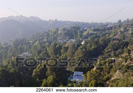 Stock Image - View Of Mountainside Homes From Mulholland Drive; Los Angeles California Usa. Fotosearch