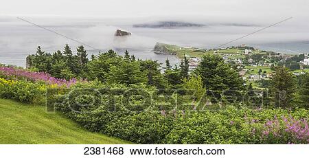 Stock Photo - View of Perce Rock through the fog from Mont-Sainte-Anne; Perce, Quebec, Canada. Fotosearch