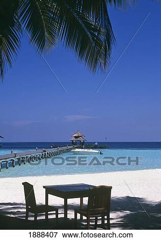 View Of Pier With Table And Chairs On White Sand Beach View Large Photo Image Stock Photo - View Of Pier With Table And Chairs On White Sand Beach. Fotosearch