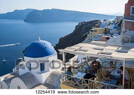 View of the Aegean sea and buildings on the hillside above; Oia, Santorini, Greece View Large Photo Image Stock Photo - View of the Aegean sea and buildings on the hillside above; Oia, Santorini, Greece. Fotosearch