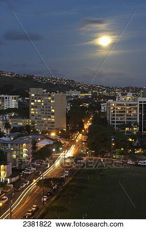 View of the city of Honolulu at night with buildings and road illuminated; Honolulu, Oahu, Hawaii, United States of America View Large Photo Image Stock Image - View of the city of Honolulu at night with buildings and road illuminated; Honolulu, Oahu, Hawaii, United States of America. Fotosearch