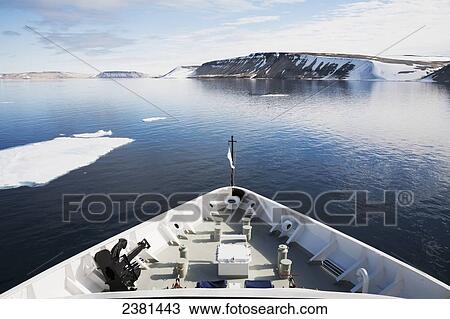 Stock Image - View of the coastline of an island of Svalbard from a cruise ship; Svalbard, Norway. Fotosearch