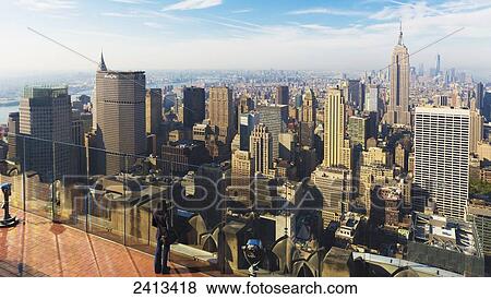 Stock Photo - View of the Empire State Building and Manhattan from the Top of the Rock Observation Tower at the Rockefeller Center; New York City, New York, United States of America. Fotosearch