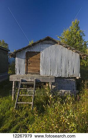 View of the front door of a bear cache with silver metal corrugated siding, Shungnak, Arctic Alaska, summer View Large Photo Image Stock Photo - View of the front door of a bear cache with silver metal corrugated siding, Shungnak, Arctic Alaska, summer. Fotosearch