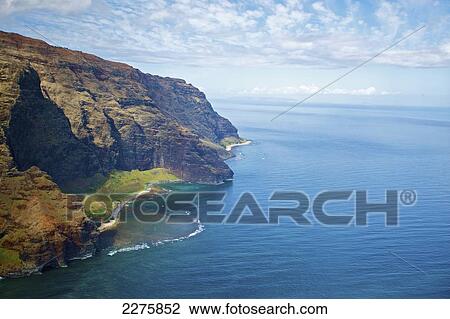 View of the rugged coastline along a hawaiian island, Na Pali coast; Kauai, Hawaii, United States of America View Large Photo Image Stock Image - View of the rugged coastline along a hawaiian island, Na Pali coast; Kauai, Hawaii, United States of America. Fotosearch