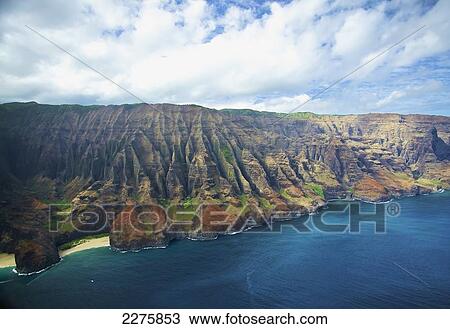 View of the rugged coastline along a hawaiian island, Na Pali coast; Kauai, Hawaii, United States of America View Large Photo Image Stock Image - View of the rugged coastline along a hawaiian island, Na Pali coast; Kauai, Hawaii, United States of America. Fotosearch