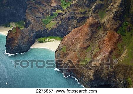 Stock Photo - View of the rugged coastline along a hawaiian island, Na Pali coast; Kauai, Hawaii, United States of America. Fotosearch