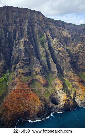 Stock Photo - View of the rugged coastline along a hawaiian island, Na Pali coast; Kauai, Hawaii, United States of America. Fotosearch