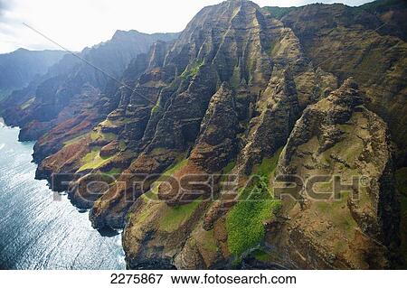 Stock Photo - View of the rugged coastline along a hawaiian island, Na Pali coast; Kauai, Hawaii, United States of America. Fotosearch