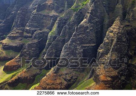 Stock Photograph - View of the rugged coastline along a hawaiian island, Na Pali coast; Kauai, Hawaii, United States of America. Fotosearch