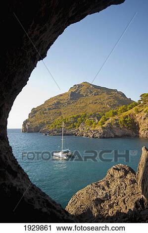 View of the sea from a hole in a rock; Sa Calobra, Mallorca, Balearic Islands, Spain View Large Photo Image Stock Image - View of the sea from a hole in a rock; Sa Calobra, Mallorca, Balearic Islands, Spain. Fotosearch