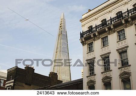 Stock Image - View of the Shard skyscraper from Borough High Street; London, England. Fotosearch