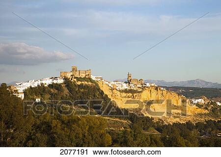 View Of The Town On A Hill With Mountains In The Background; Arcos De La Frontera Andalusia Spain View Large Photo Image Stock Image - View Of The Town On A Hill With Mountains In The Background; Arcos De La Frontera Andalusia Spain. Fotosearch