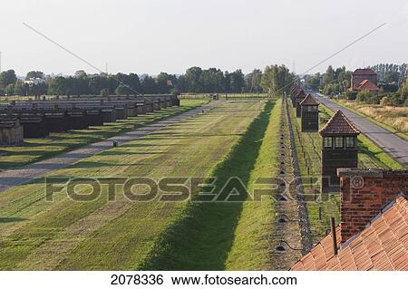 Stock Photograph - View Of The Watchtowers Along The Camp Perimeter From The Main Guard House (Gate Of Death), Auschwitz-Birkenau Concentration Camp, Oswiecim, Malopolska, Poland. Fotosearch