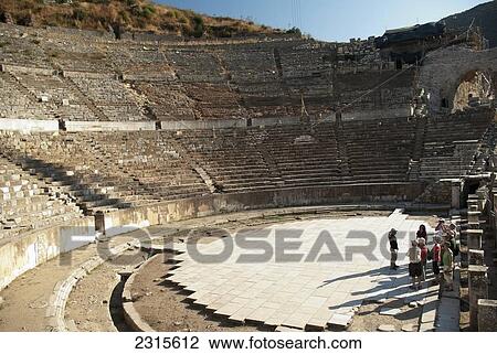 Stock Image - View of Tourists and guide on stage of theatre; Ephesus, Izmir Province, Turkey. Fotosearch